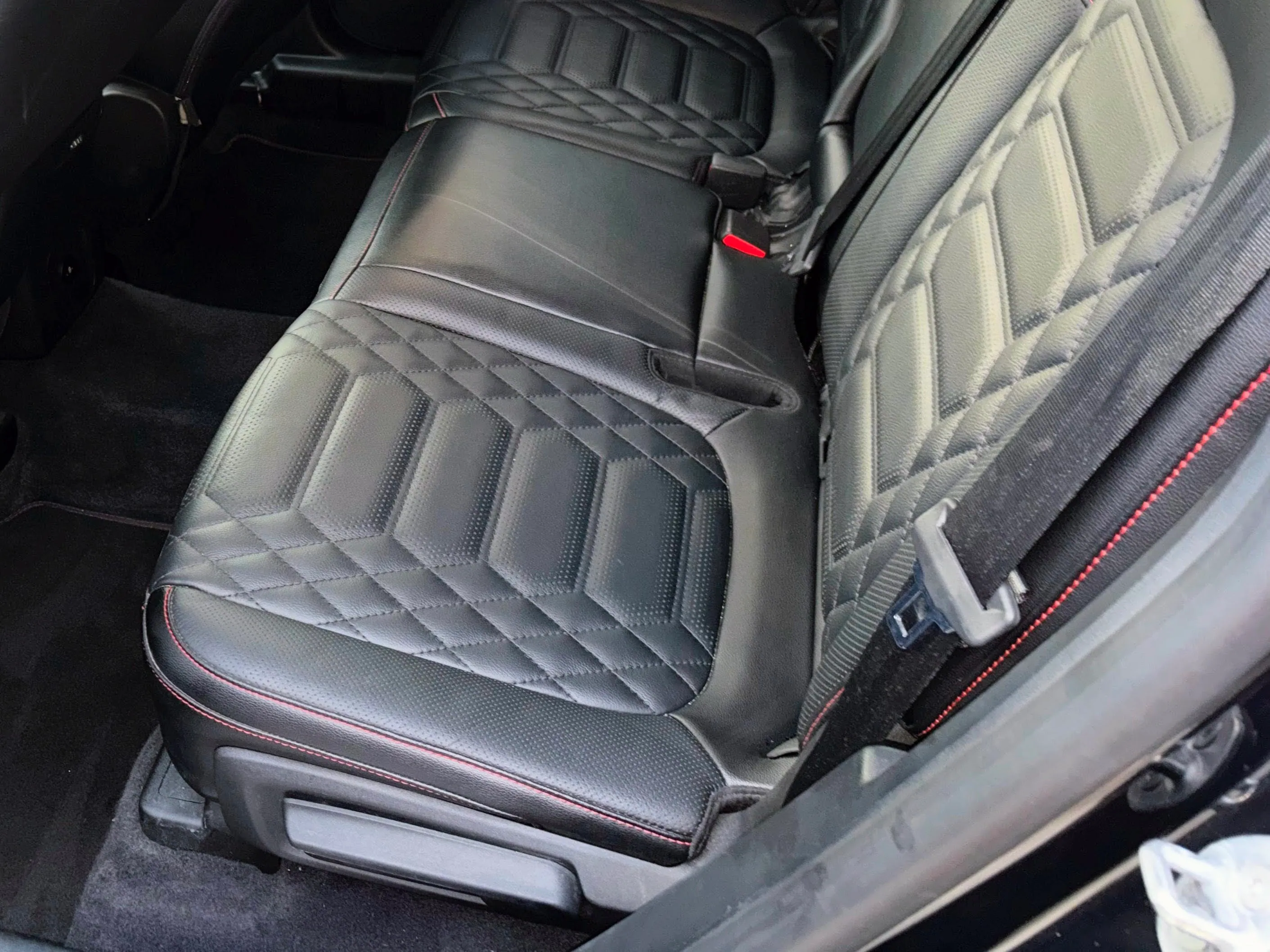 Vacuuming and detailing luxury vehicle interior dashboard